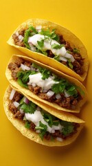 Taco photography featuring ground beef, onion, cilantro and sour cream against a yellow background