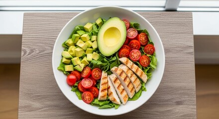 Chicken avocado salad bowl with fresh vegetables