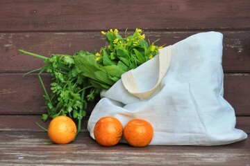 Fresh Fruits and Vegetables in a tote bag on a  wooden table Background.Use tote bag for Replacement plastic bag can save the earth.Zero Waste, Healthy Eating, Package Free,Green Living concept.