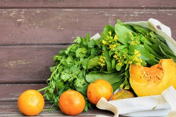 Fresh Fruits and Vegetables in a tote bag on a  wooden table Background.Use tote bag for...