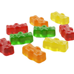Small, translucent, bear-shaped gummy candies (ruby red, emerald green, tangerine orange, lemon yellow), glossy, scattered on transparent. Ultra-realistic high-angle product shot with bright,