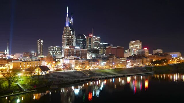 Colorful skyline of Nashville, Tennessee as seen from the John Seigenthaler Pedestrian Bridge over the Cumberland River. Shot in time lapse in long exposures late at night.