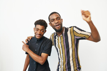 Two smiling African American men celebrating together in a casual setting, expressing joy and...
