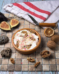 Gourmet walnut ice cream served in a glass bowl, topped with whipped cream and crunchy nuts