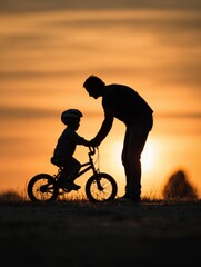 Obraz premium Father Teaches Child to Ride Bike During Sunset in a Serene Outdoor Setting