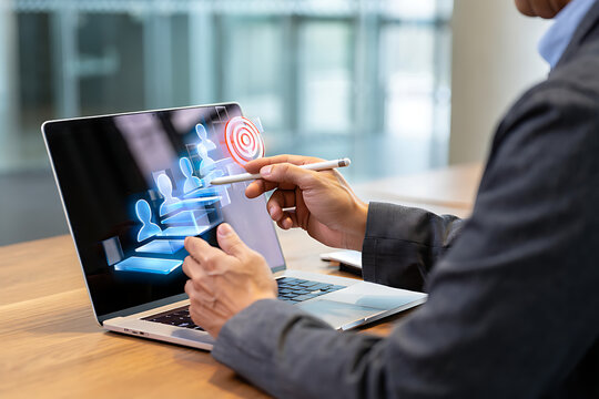 Businessman targeting customer profile using digital marketing tools on laptop for customer segmentation and lead generation