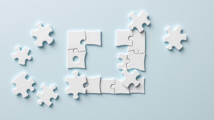 White jigsaw puzzle pieces scattered and partially assembled forming a square shape on a light blue background