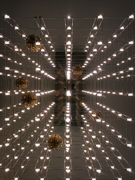 Infinity Mirror Illusion with Glowing Grid and Golden Orbs