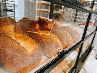Freshly baked artisan loaves displayed in a modern bakery during morning hours