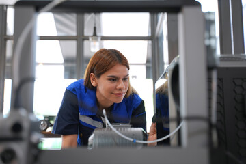Engineer is working at 3D printing workshop.