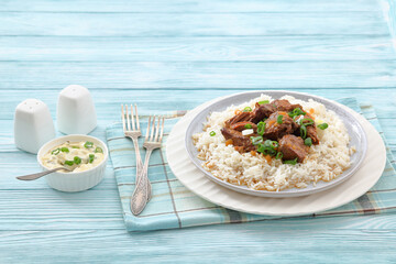 beef slow cooked with gravy served over rice
