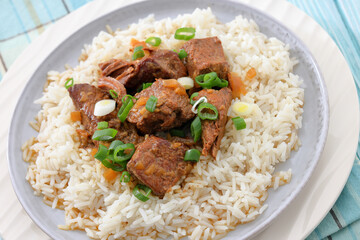 beef slow cooked with gravy served over rice