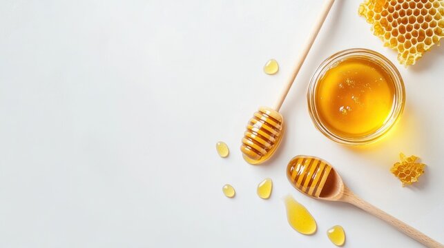 Honeycombs and honey in a jar, drizzled on white surface