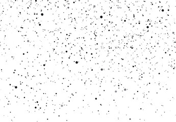 Obraz premium A speckled black and transparent background texture with a random dot pattern