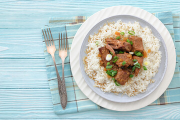 beef slow cooked with gravy served over rice