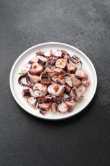 Octopus salad on white  plate for Mediterranean cuisine or healthy seafood concept