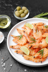 Close-up of large shrimp with lime on dark background for luxury seafood or catering concept