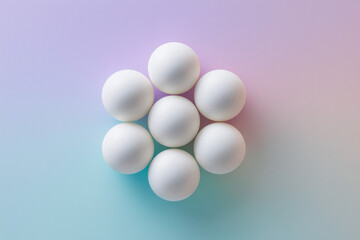 White spheres arranged symmetrically on a soft pastel background 