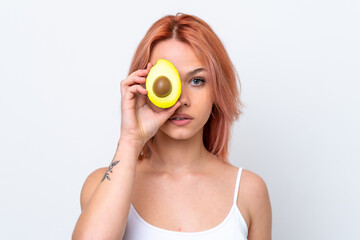 Young Russian girl isolated on white background holding an avocado. Close up portrait
