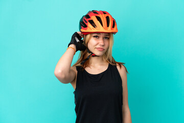 Young cyclist girl over isolated blue background having doubts