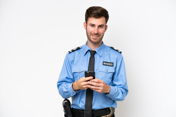 Young police caucasian man isolated on white background sending a message with the mobile