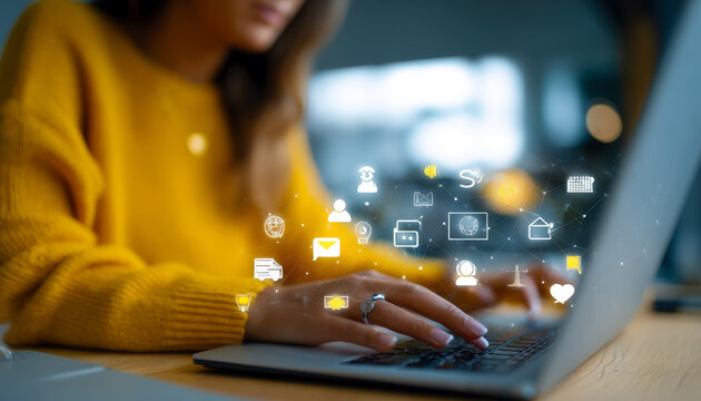 Woman using a laptop with digital communication and social media icons overlay