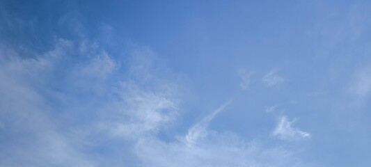 Sky is blue and clear with no clouds. The sky is very bright and the sun is shining. Blue sky with scattered white clouds creating a serene and peaceful atmosphere.