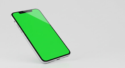 Silver smartphone displaying a green screen on a white surface in a studio setting for product mockup