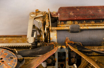 Close up of the carriage mechanism of an old rusty typewriter