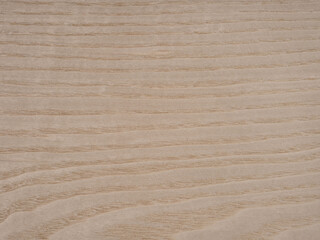 Light brown ash veneer surface, with a flowing grain and warm, soft hues.