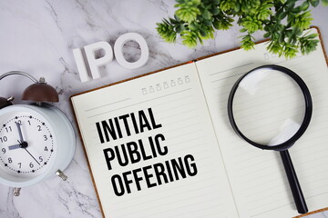 IPO - Initial Public Offering acronym on notepad, Business concept background