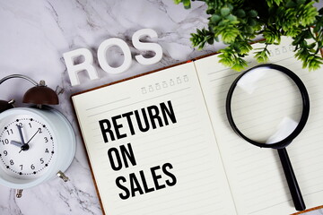 ROS - Return On Sales acronym on notepad, Business concept background