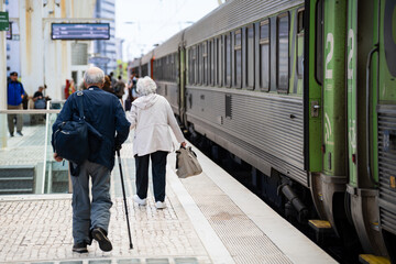 Old woman and man on the railway platform
