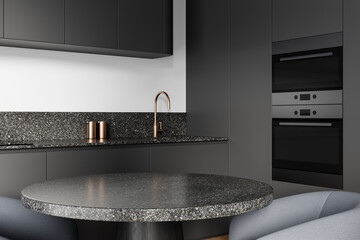 Modern kitchen interior with minimalist design, featuring dark matte cabinetry, terrazzo surfaces,...
