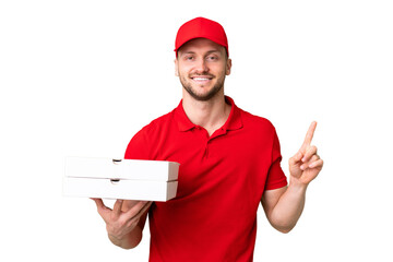 Pizza delivery man with work uniform picking up pizza boxes over isolated chroma key background...