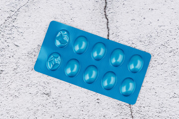 Blue blister pack of Rybelsus tablets on concrete surface, top view pharmaceutical image for...