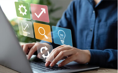 A digital illustration of hands typing on a silver laptop keyboard with floating holographic icons.