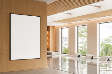 Blank framed poster mockup in modern spa interior with wood panel wall and poolside lounge chairs...