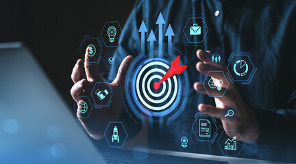 Business target and growth strategy concept with digital icons and red dart hitting bullseye...