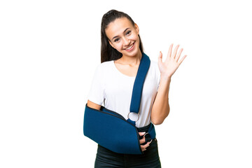 Young Arabian woman with broken arm and wearing a sling over isolated chroma key background...