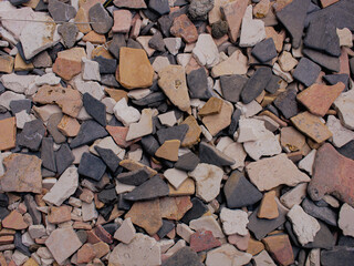 A textured full frame of various broken pottery shards and natural stone fragments. Ideal for...