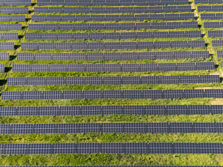 Aerial view of solar power station on a green field. Sustainable development