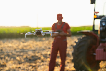 Farmer controls drone on a field. Smart farming and precision agriculture