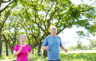Happy Asian Senior couple running outdoor