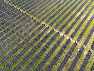 Aerial view of solar power station on a green field. Sustainable development