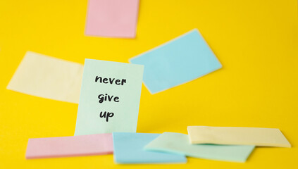 Conceptual words "Never give up" on a sticker. Business and concept "Never give up"