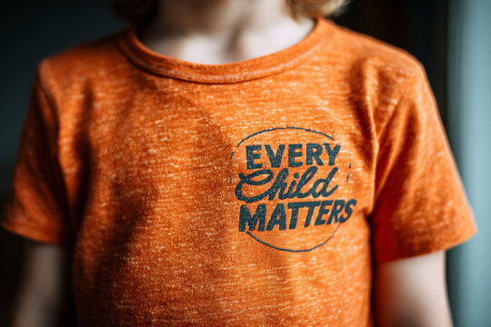 AI generation. The concept of every child matters. Indigenous peoples of America in orange shirts with the text "every child matters." A silent demonstration of "every child matters".