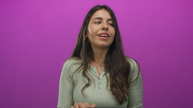 Young hispanic woman using tablet against bright pink background conveying modern technology and digital lifestyle in an isolated and focused setting. - Powered by Adobe
