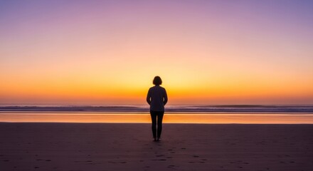Silhouette of Person Walking on Beach at Sunset with Purple Sky