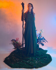 Dramatic portrait of female model figure wearing green fantasy fae cloak costume.
Colourful backlit...